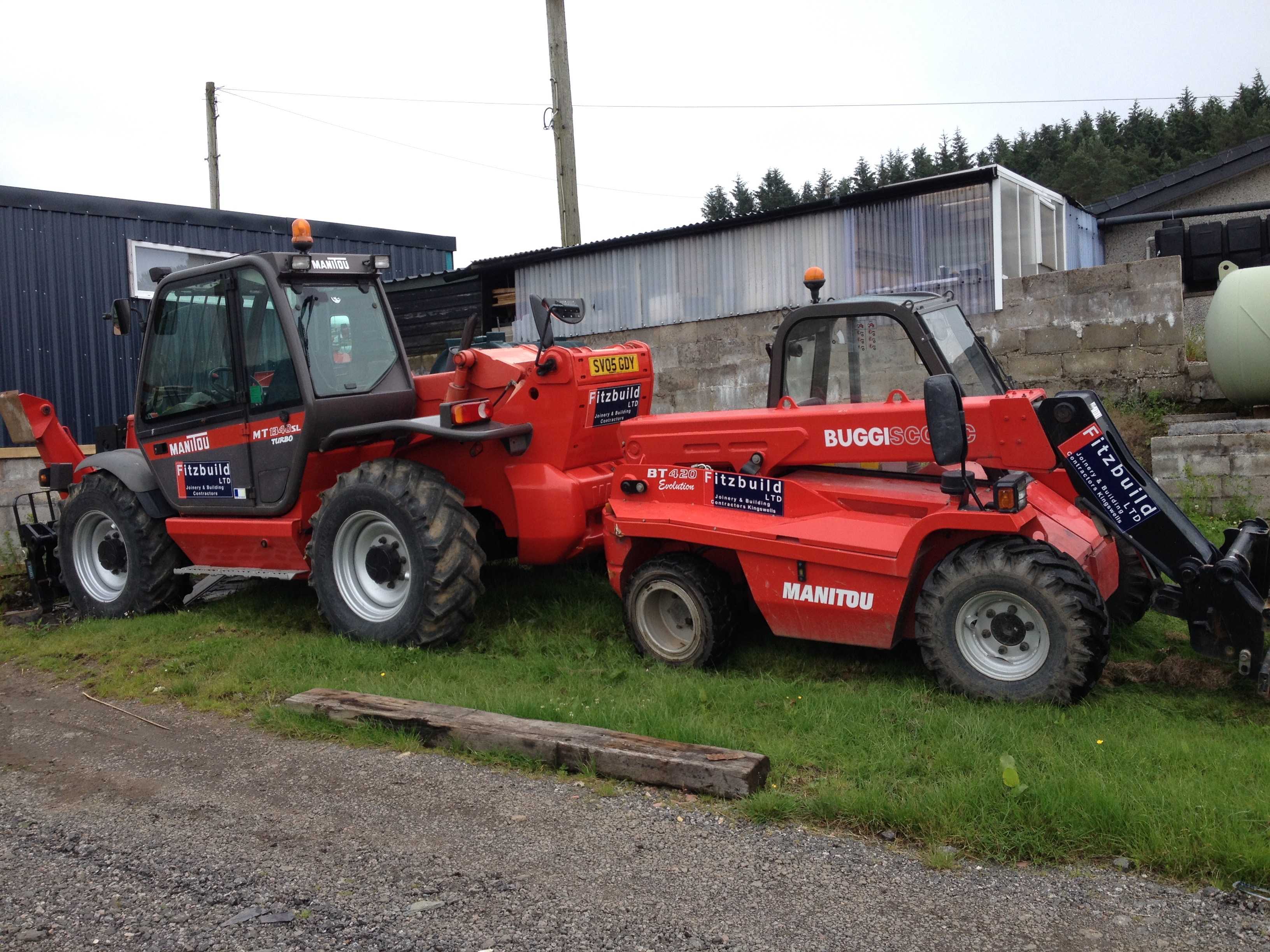 Two construction vehicles parked on a grass verge outside the Fitzbuild yard.